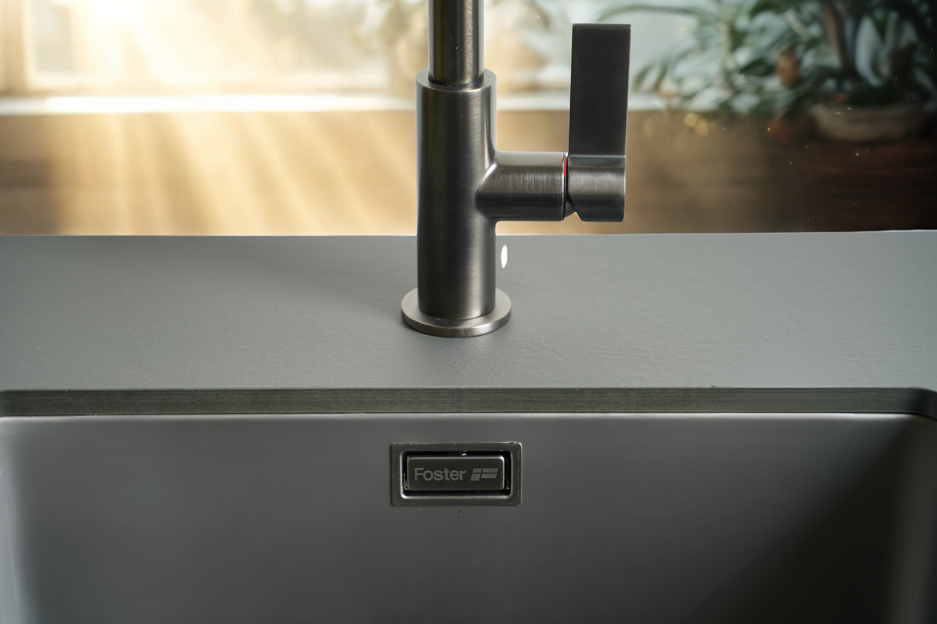 Sink bowl in gunmetal fumé finish paired with satin gunmetal mixer